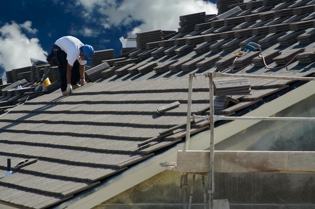 man installing a new roof
